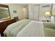 Charming bedroom featuring a neutral palette, closet, and dresser with mirror, providing a comfortable retreat at 113 Temple W Cv, Leesburg, FL 34748