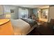 Bedroom featuring an attached bathroom with a relaxing chair, offering comfort and convenience at 113 Temple W Cv, Leesburg, FL 34748
