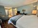 This bedroom includes an attached bathroom and vanity, a workspace and comfy chair at 113 Temple W Cv, Leesburg, FL 34748