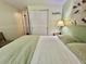 Inviting bedroom with soft lighting, spacious closet, and minimalist decor, offering a calm and relaxing environment at 113 Temple W Cv, Leesburg, FL 34748