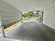 Attached carport providing covered parking and protection from the elements at 113 Temple W Cv, Leesburg, FL 34748