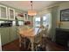 Dining area with wooden table, ample natural light, and adjacent kitchen, great for everyday meals and entertaining at 113 Temple W Cv, Leesburg, FL 34748