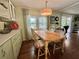 Cozy dining area featuring a wooden table, seating for four, and natural light, perfect for meals at 113 Temple W Cv, Leesburg, FL 34748