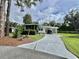Quaint single-story home featuring a carport, a screened in porch, and mature landscaping at 113 Temple W Cv, Leesburg, FL 34748