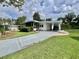View of the mobile home featuring a driveway and covered carport at 113 Temple W Cv, Leesburg, FL 34748