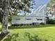 Well-maintained mobile home with lush lawn and mature trees at 113 Temple W Cv, Leesburg, FL 34748
