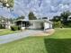 Well-kept mobile home with a covered carport and a charming screened-in porch at 113 Temple W Cv, Leesburg, FL 34748