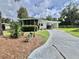 Charming home with well-manicured landscaping and a covered carport at 113 Temple W Cv, Leesburg, FL 34748