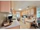 Bright kitchen features light colored cabinetry, a built-in desk, and appliances, offering functionality and charm at 113 Temple W Cv, Leesburg, FL 34748