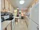 Efficient kitchen featuring white appliances, ample cabinetry, and functional layout, ideal for comfortable meal preparation at 113 Temple W Cv, Leesburg, FL 34748