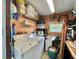 A laundry room with a washer, dryer, shelving for storage, and wood walls at 113 Temple W Cv, Leesburg, FL 34748
