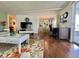 Relax in this living room with media center, comfortable seating and an adjacent dining and kitchen area at 113 Temple W Cv, Leesburg, FL 34748