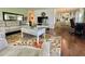 This living room offers a cozy seating area, modern TV setup, and seamless flow into the dining and kitchen area at 113 Temple W Cv, Leesburg, FL 34748