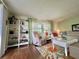 Bright living room featuring a comfortable seating arrangement and stylish bookcase with ample natural light at 113 Temple W Cv, Leesburg, FL 34748