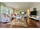 This comfortable living room includes cozy seating, a media center and seamless flow into the kitchen and dining area at 113 Temple W Cv, Leesburg, FL 34748