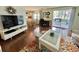 Inviting living room featuring hard surface flooring, floral rug, and sliding glass doors to outdoor space at 113 Temple W Cv, Leesburg, FL 34748