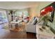 Inviting living room with hardwood floors, cozy seating arrangement, and natural light, creating a comfortable atmosphere at 113 Temple W Cv, Leesburg, FL 34748
