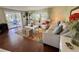 Relaxing living room with comfortable seating, stylish rug, and access to a screened-in patio, great for Gathering time at 113 Temple W Cv, Leesburg, FL 34748