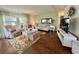 Cozy living room with contemporary furnishings, hardwood floors, and a bright ambiance, perfect for entertaining guests at 113 Temple W Cv, Leesburg, FL 34748
