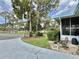 Close-up view of the front entrance, featuring a charming bench and landscaping at 113 Temple W Cv, Leesburg, FL 34748