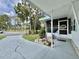 Inviting entrance with a covered walkway and a welcoming bench at 113 Temple W Cv, Leesburg, FL 34748