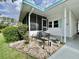 Charming front porch area with decorative bench and stylish landscaping at 113 Temple W Cv, Leesburg, FL 34748