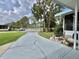 Beautifully landscaped front of home featuring front bench and mature trees at 113 Temple W Cv, Leesburg, FL 34748