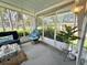 Relaxing screened-in porch with comfortable seating and bright, natural light at 113 Temple W Cv, Leesburg, FL 34748