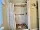 Well-maintained tiled shower with grab bar and updated fixtures, providing a safe and functional bathing space at 113 Temple W Cv, Leesburg, FL 34748