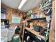 Interior storage shed with pegboard wall and overhead shelving at 113 Temple W Cv, Leesburg, FL 34748
