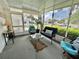 Relaxing sunroom with comfortable seating and views of the outdoors, creating a tranquil space at 113 Temple W Cv, Leesburg, FL 34748