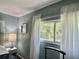 Sunlight streaming in, highlighting lush foliage through a bedroom window at 113 Temple W Cv, Leesburg, FL 34748
