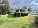 Well-maintained lawn surrounding a single-story home in a quiet neighborhood at 113 Temple W Cv, Leesburg, FL 34748