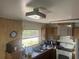 Functional kitchen with stainless steel sink, retro cabinets, and ample natural light at 11651 Fairmont Ave, Leesburg, FL 34788