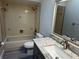 Bathroom features a vanity with stone countertop and a tiled tub and shower combination at 11681 Se 72Nd Court Rd, Belleview, FL 34420