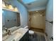 Bathroom featuring vanity with stone countertop, skylight, and a tiled walk-in shower at 11681 Se 72Nd Court Rd, Belleview, FL 34420