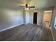 Bedroom showing wood-look flooring, closet, and access to the bathroom with tiled shower at 11681 Se 72Nd Court Rd, Belleview, FL 34420