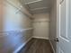 Walk-in closet with wood-look flooring and adjustable wire shelving for optimal storage at 11681 Se 72Nd Court Rd, Belleview, FL 34420