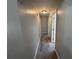 Hallway featuring neutral paint and wood-look flooring, leading to other rooms at 11681 Se 72Nd Court Rd, Belleview, FL 34420