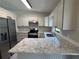 Gourmet kitchen featuring granite countertops, stainless steel appliances, and ample storage space at 11681 Se 72Nd Court Rd, Belleview, FL 34420