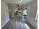 Modern kitchen view overlooking the dining area and leading to an outdoor patio at 11681 Se 72Nd Court Rd, Belleview, FL 34420
