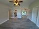 Inviting living room featuring vaulted ceilings and modern gray wood-look floors at 11681 Se 72Nd Court Rd, Belleview, FL 34420