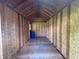 Spacious unfinished shed interior featuring plywood walls, flooring, and storage potential at 11681 Se 72Nd Court Rd, Belleview, FL 34420