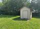 Exterior view of shed in lush green backyard at 11681 Se 72Nd Court Rd, Belleview, FL 34420