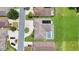 Bird's eye view of a home's roof, driveway, and a screened pool in a residential area at 12407 Ne 48Th Loop, Oxford, FL 34484