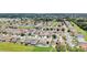 Wide aerial shot showcasing a well-maintained neighborhood with neatly arranged homes at 12407 Ne 48Th Loop, Oxford, FL 34484