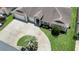 An aerial view showcasing the home's three-car garage, landscaped yard and circular driveway at 12407 Ne 48Th Loop, Oxford, FL 34484