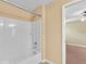 Bright bathroom featuring a tub and shower combination with a modern faucet at 12407 Ne 48Th Loop, Oxford, FL 34484