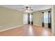 Spacious bedroom with a ceiling fan, neutral paint, and a double-door closet at 12407 Ne 48Th Loop, Oxford, FL 34484