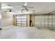 Spacious garage with two garage doors and ceiling fan at 12407 Ne 48Th Loop, Oxford, FL 34484